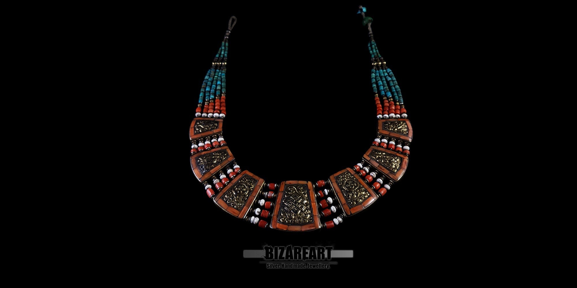 Full view of the reversible side of the vintage Nepalese necklace, featuring intricate bronze details and red coral mosaic patterns.