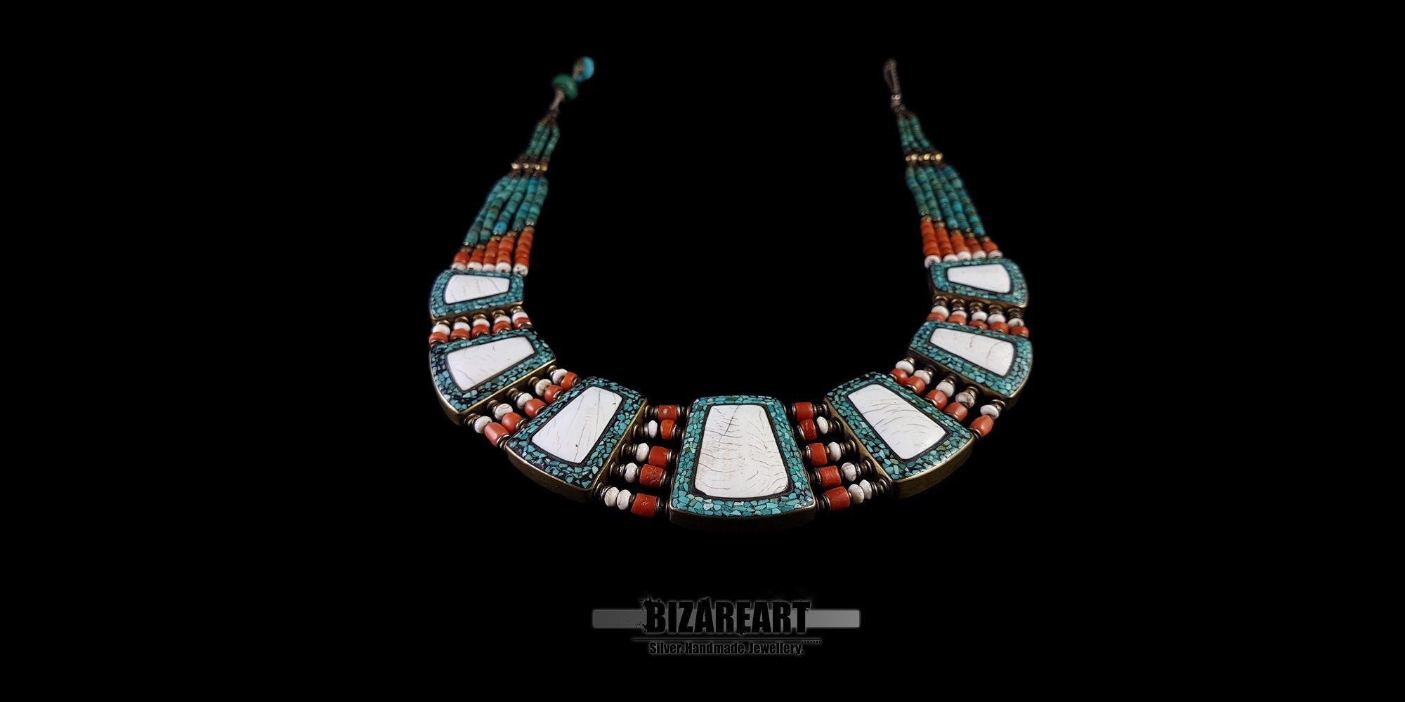 Full view of a double-sided vintage Himalayan necklace showcasing the white conch shell and turquoise inlay side against a grey background.