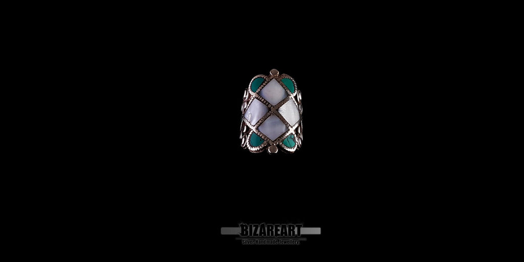 Front view of a vintage Tibeto-Nepalese silver statement ring featuring an intricate rhombus pattern inlay of white conch shell and turquoise stones.
