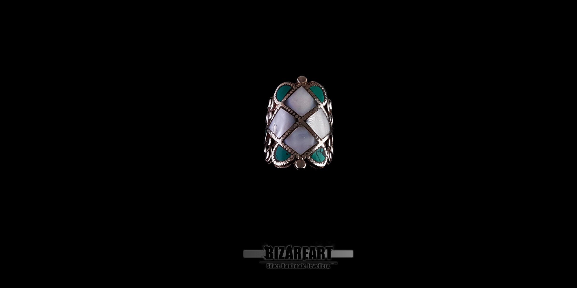 Front view of a vintage Tibeto-Nepalese silver statement ring featuring an intricate rhombus pattern inlay of white conch shell and turquoise stones.