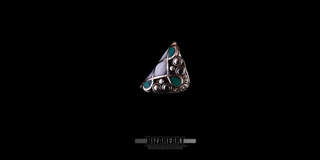Close-up profile view of the vintage turquoise and white conch silver ring, showing the textured artisan craftsmanship.