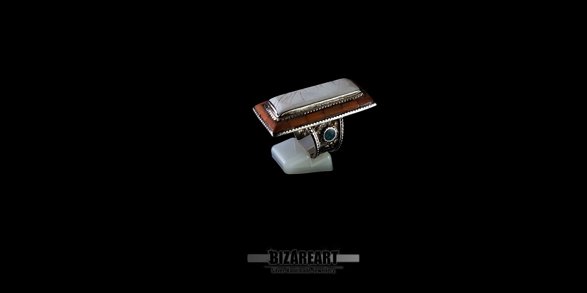 Detailed 3D perspective of a vintage Tibetan-style silver ring highlighting the straight shank band and custom thin silver rim holding secure gemstones.