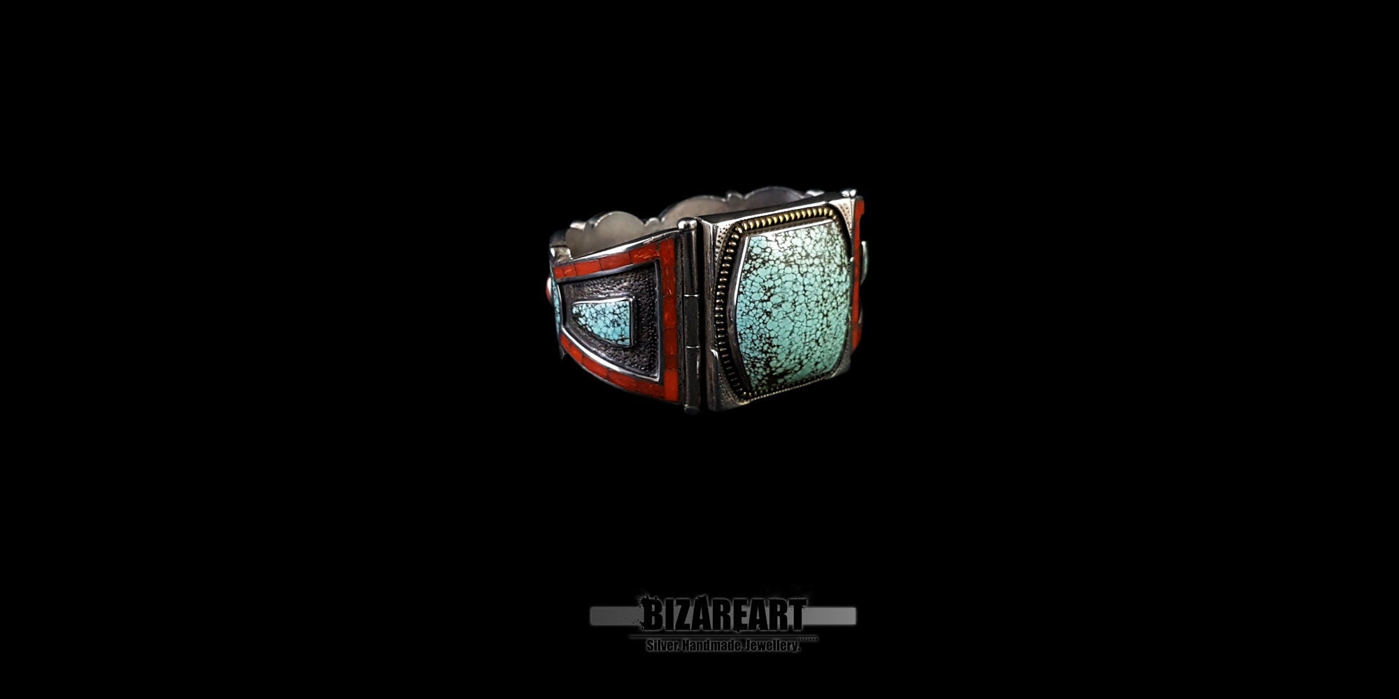 Angled close-up of the silver cuff showing the left side of the large turquoise stone and the adjacent red coral mosaic inlay panel. The bracelet is resting on a black surface.