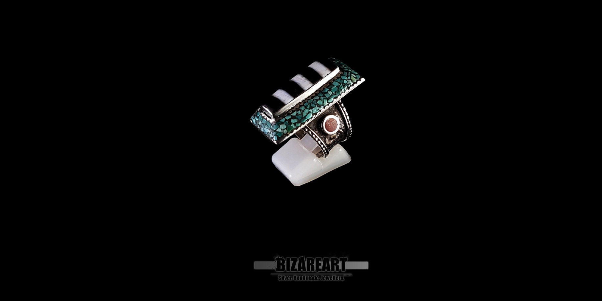 High-angle product shot of a handcrafted Himalayan vintage silver ring showing the intricate turquoise mosaic border and side coral setting.