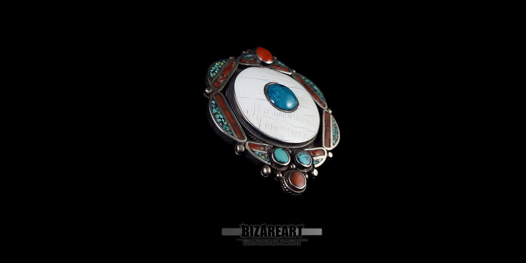 Side angle view showing the craftsmanship, thickness, and silver details of the 51g vintage Tibeto-Nepalese pendant.