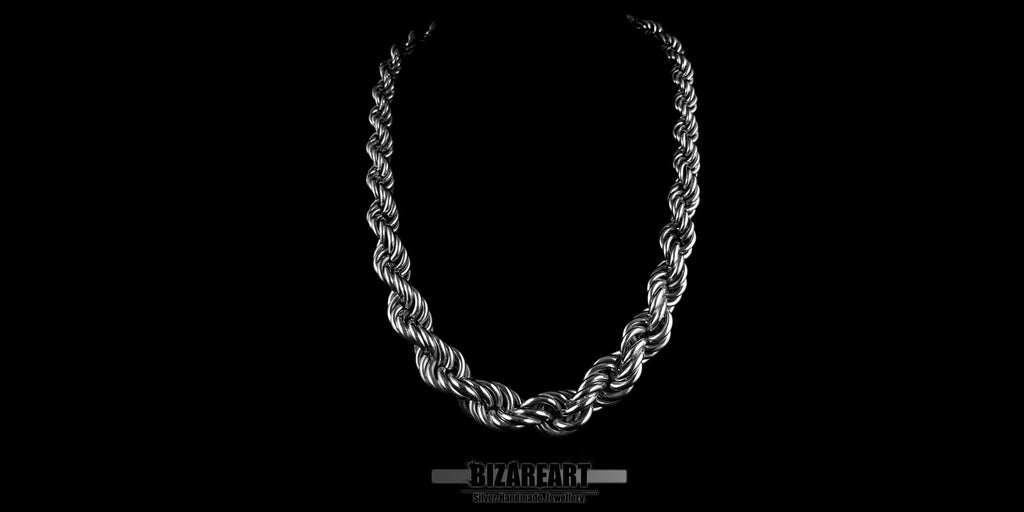 Front view of a thick, handmade .925 sterling silver Chenier rope chain necklace showcased against a high-contrast black background.