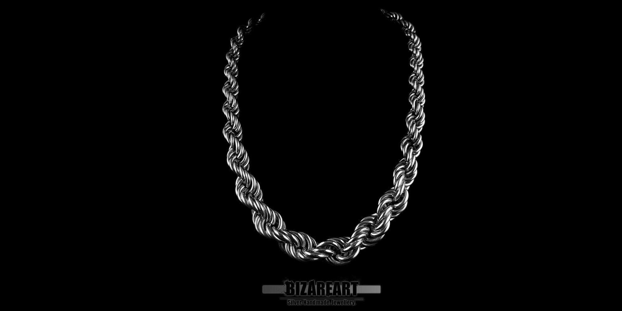 Front view of a thick, handmade .925 sterling silver Chenier rope chain necklace showcased against a high-contrast black background.