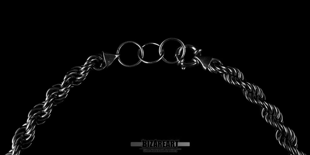 Close-up of the heavy-duty spring ring clasp on a silver rope chain, emphasizing the secure closure and industrial design.