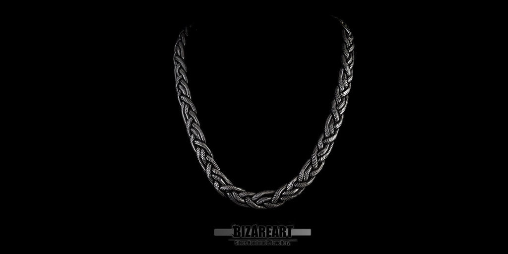 Detail shot of the intricate triple-weave pattern of the silver rope chain, showcasing the precision-soldered links.