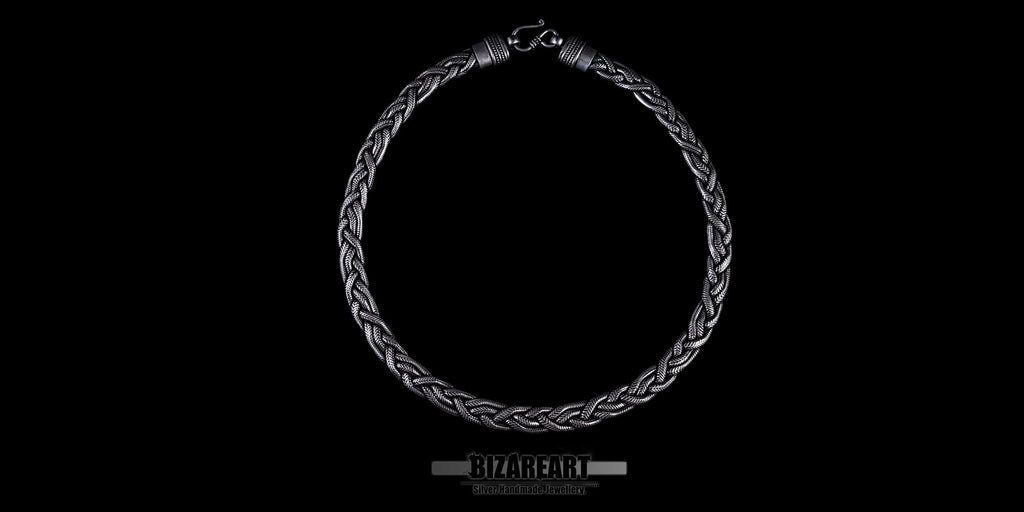 Side-angle view of the silver chain draped to show the thickness of the wire and the three-dimensional depth of the rope design.