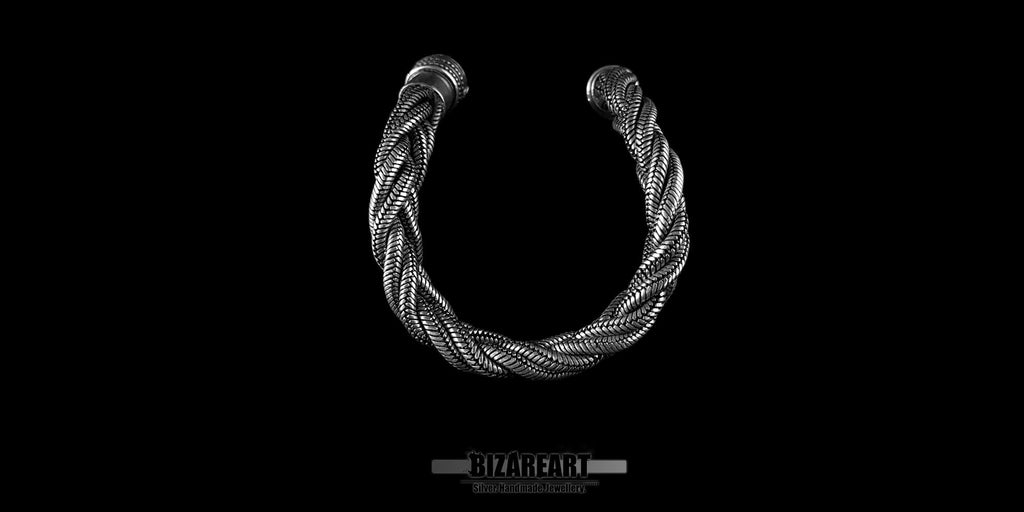 Close-up of a heavy-gauge sterling silver triple-strand rope bracelet curved in a U-shape, highlighting the intricate handmade wire weave.