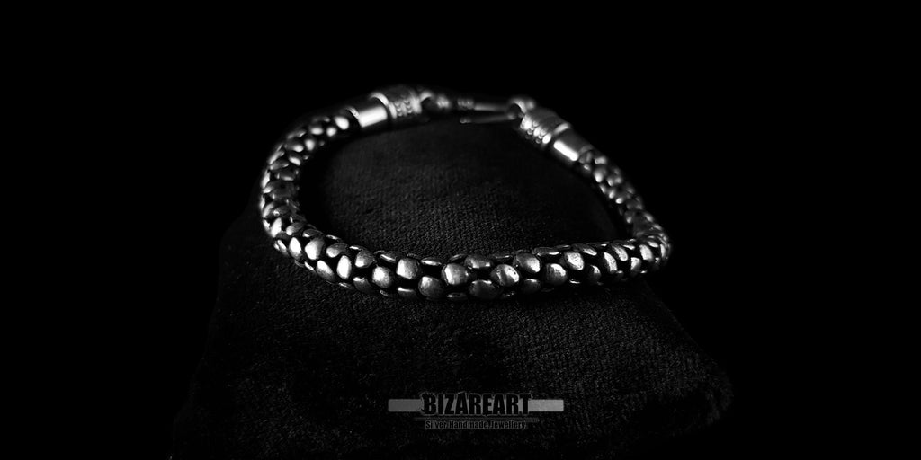 Side profile showing the rustic matte texture and detailed craftsmanship of the unisex silver bracelet.