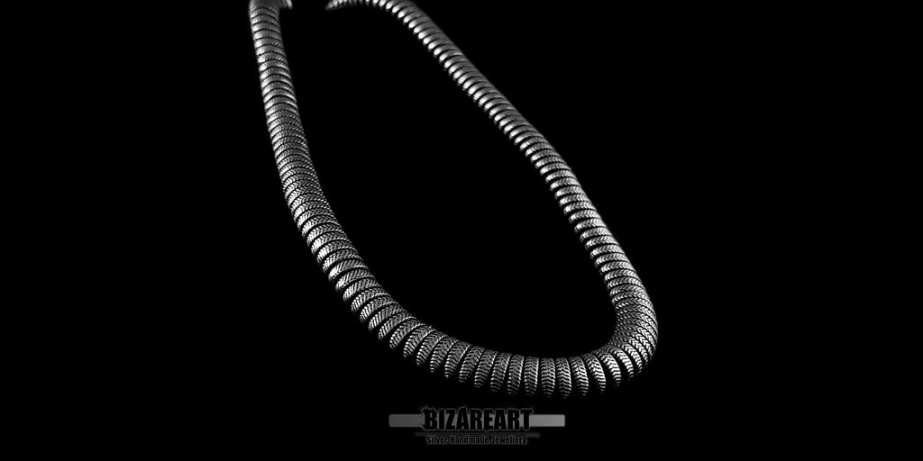 Side-angle view of the substantial Indian silver necklace, illustrating the thickness of the wide links and how the piece drapes elegantly.