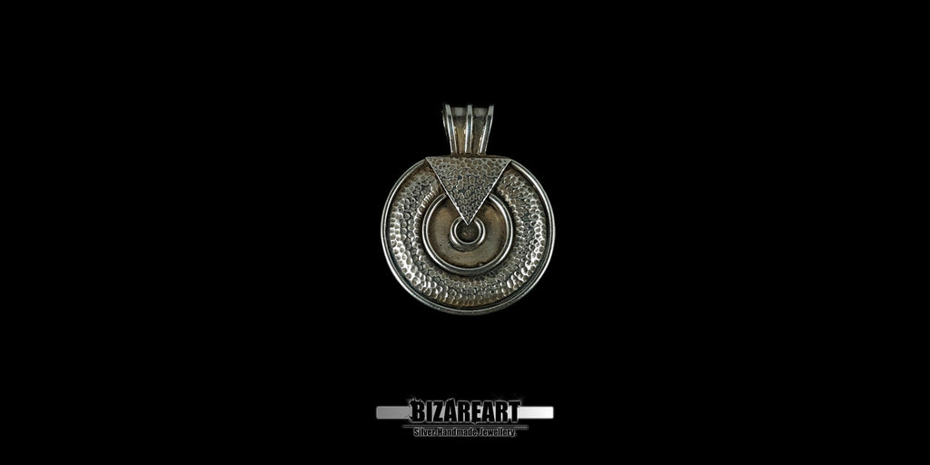 Front-facing studio shot of a handcrafted round 925 sterling silver pendant with intricate hammer-textured patterns and dark oxidized details against a black background.