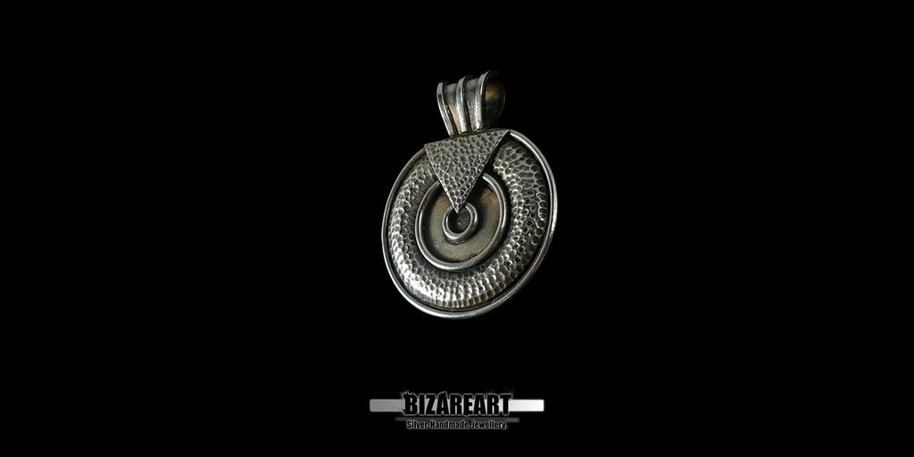 Close-up shot of the pendant's surface showcasing the high-contrast silver oxidation and the precision-soldered geometric design elements.