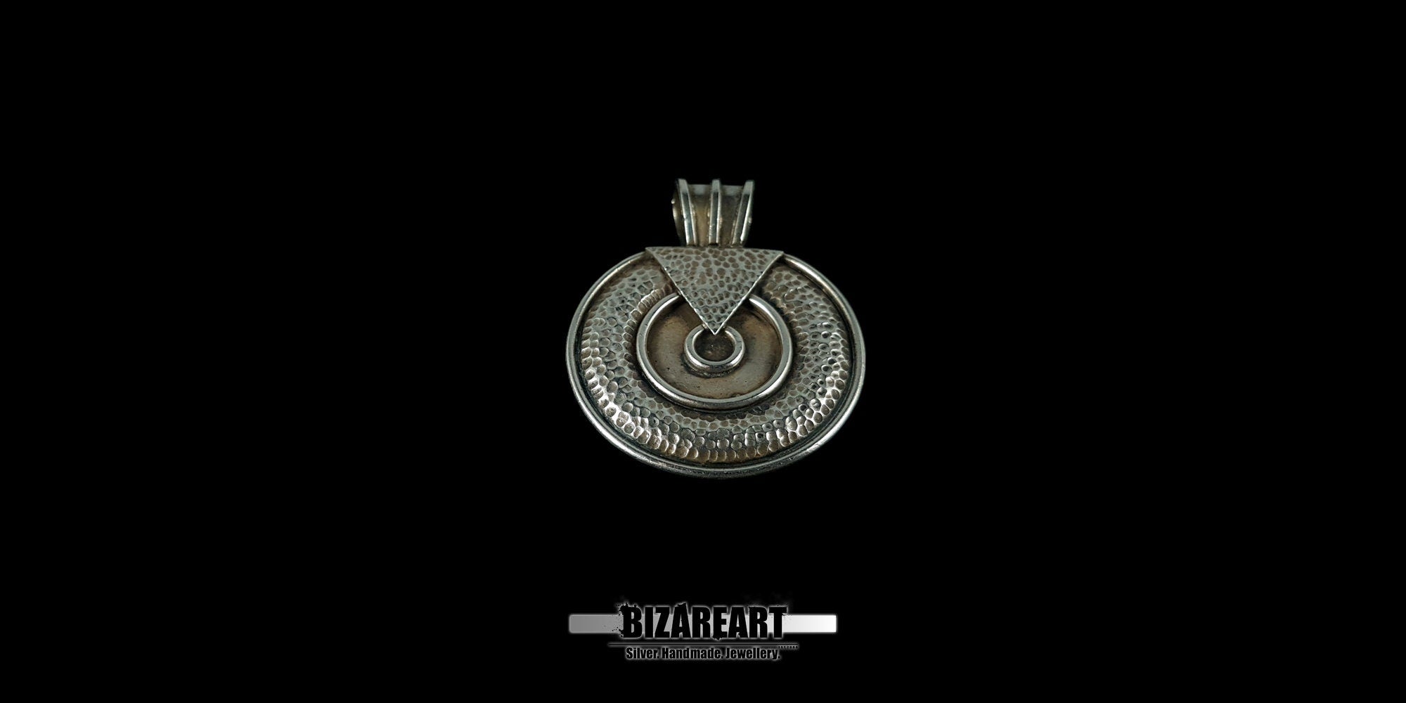 Symmetrical view of the oxidized silver pendant, emphasizing the artistic fusion of circular textures and the smooth, polished inner ring.