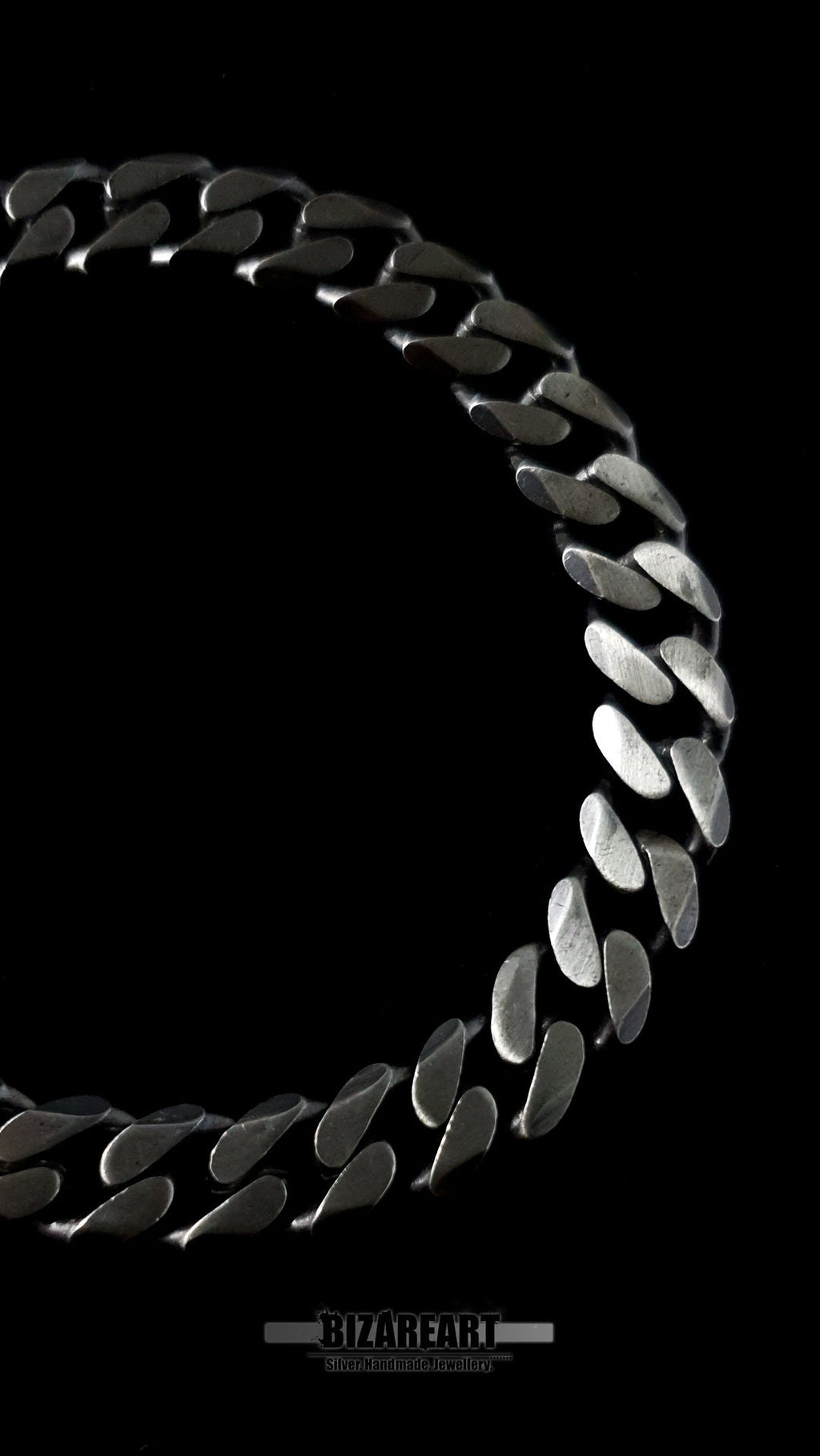 Extreme close-up of the 8.2mm wide silver links, focusing on the handmade craftsmanship and 925 hallmark quality.
