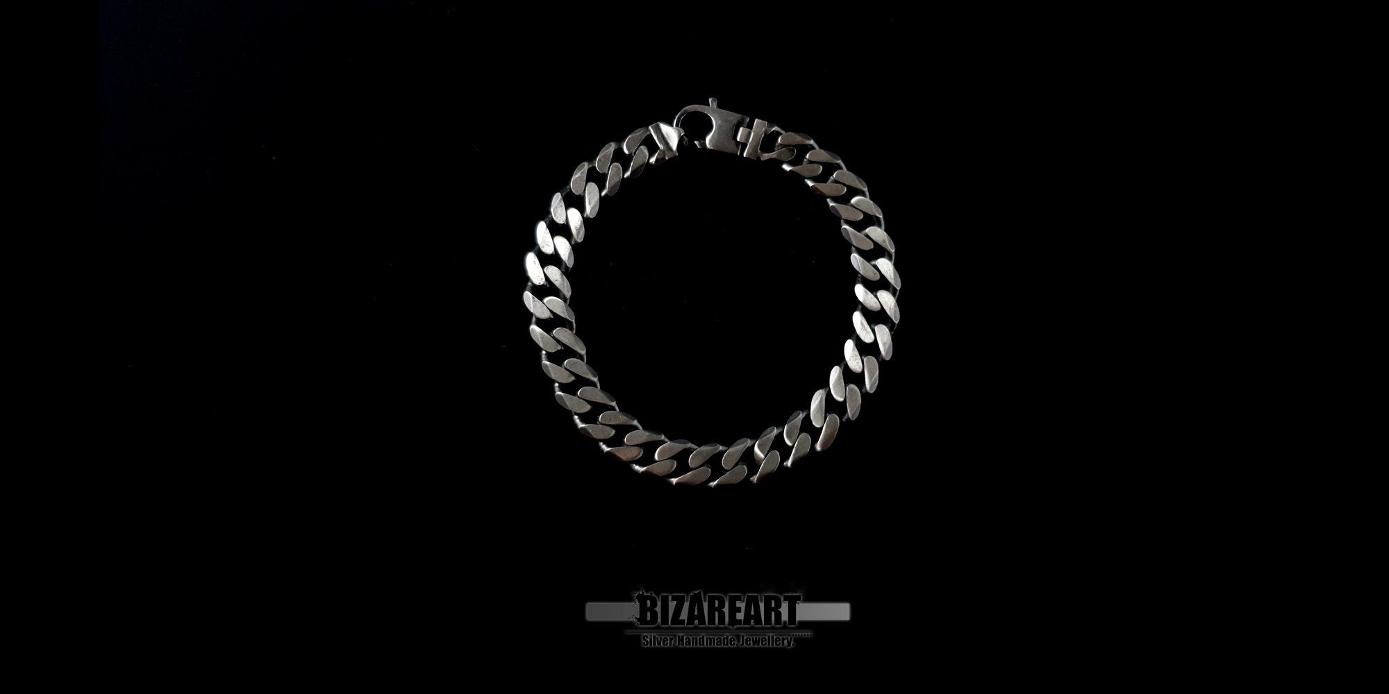 Top-down view of a thick Sterling Silver Gourmette bracelet with a flat curb chain design and an S-shaped crab clasp, displayed against a high-contrast black background.