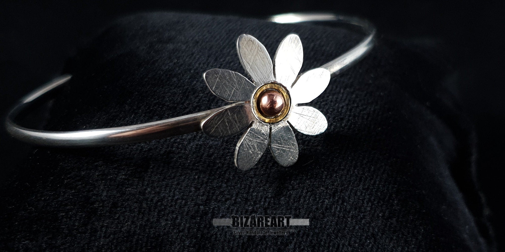 Perspective view of a high-quality 925 silver bohemian-style floral bangle showing the curve and comfortable open-back design.