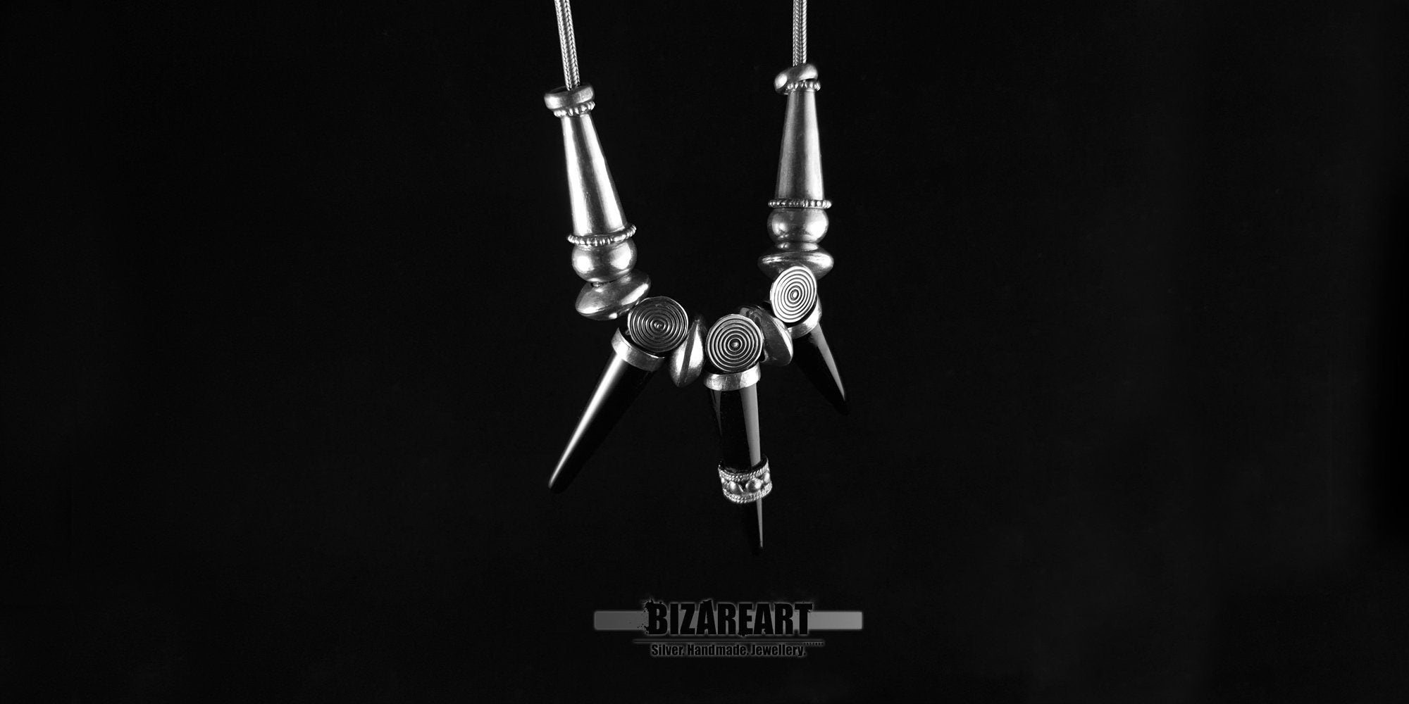 Alternative view of the Black Onyx Elegance gothic necklace emphasizing the glossy finish of the cone gemstones and premium silver loops.
