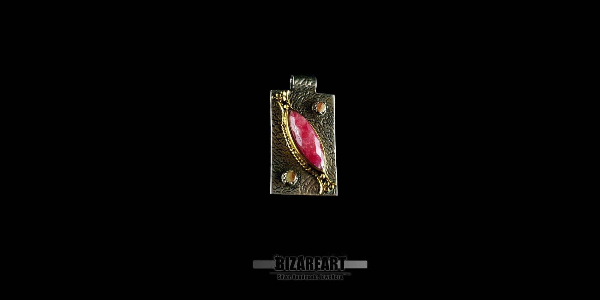 Studio shot showcasing the scale and rectangular silhouette of the BIZAREART ruby pendant.