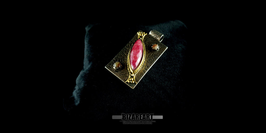 Side view of textured BIZAREART sterling silver pendant featuring a vibrant pink ruby.