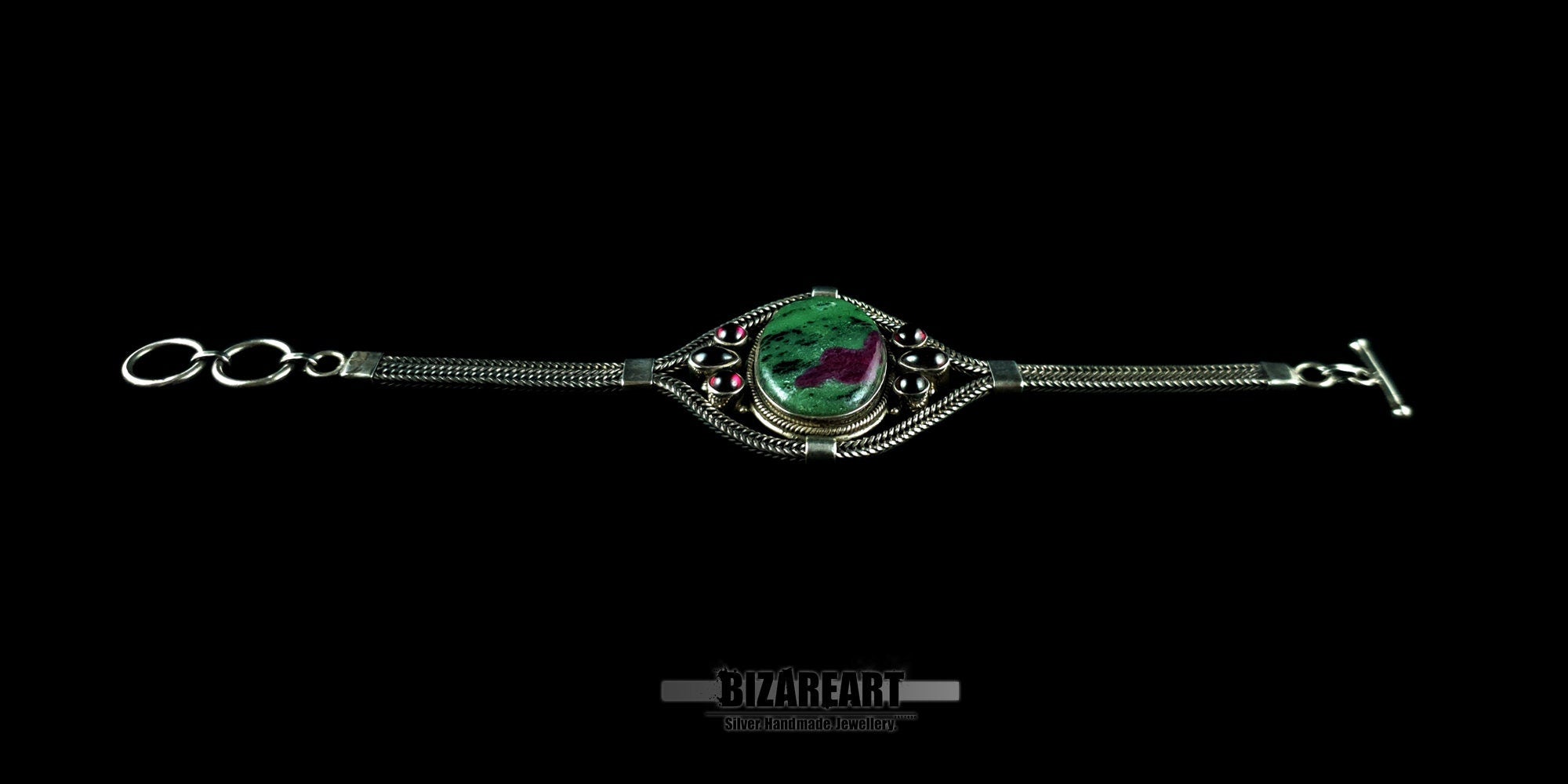 Overhead shot of the handmade sterling silver bracelet showing the intricate gemstone settings.