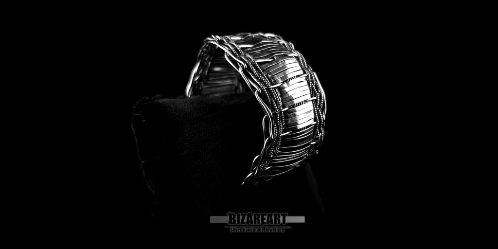 Side profile of the multilayered silver cuff, highlighting the substantial texture and depth of the layered wire construction.