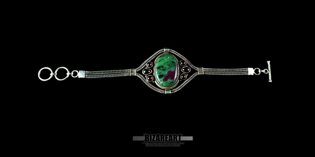 Flat lay view of the adjustable silver chain and toggle closure of the Ruby Zoisite bracelet.