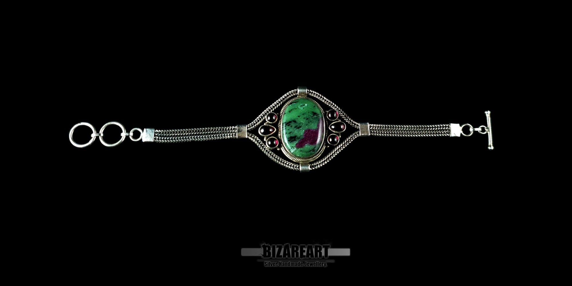 Flat lay view of the adjustable silver chain and toggle closure of the Ruby Zoisite bracelet.
