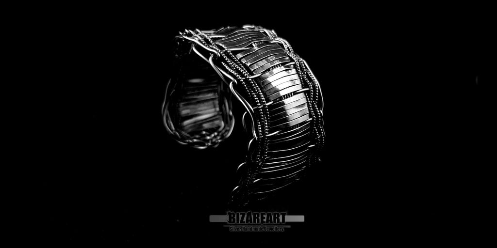 Three-quarter angled view of the handcrafted multilayered silver cuff, highlighting the bold architectural shape and oxidized wire details.