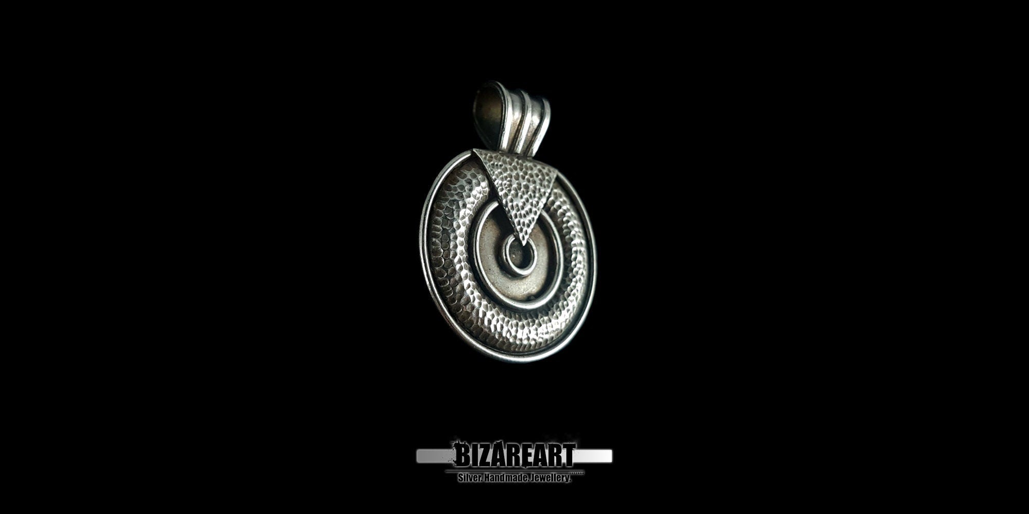 Side-angle view of the round silver pendant highlighting the substantial 3.77mm thickness and the decorative large hinge bale.