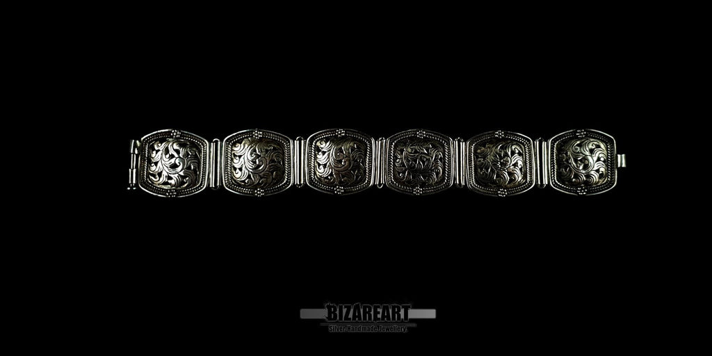 An overhead view of the six individual hand-engraved silver panels linked together to show the full floral pattern layout.