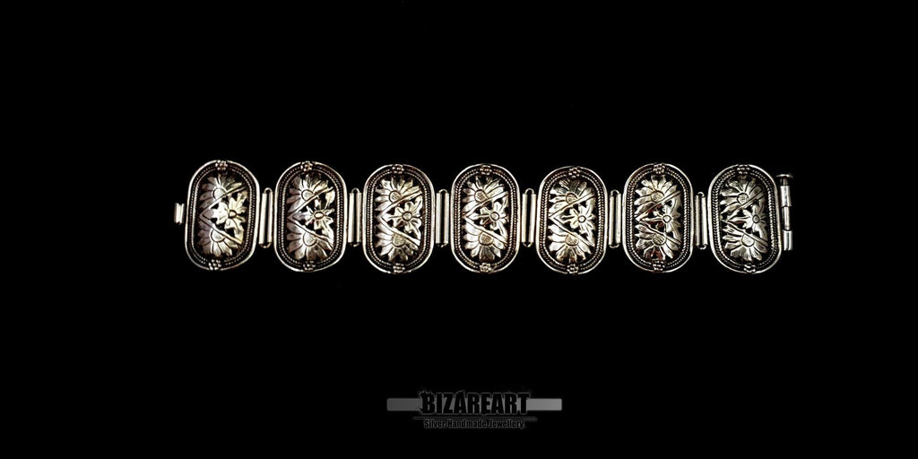 Full length view of the 19cm sterling silver bracelet laid completely flat, showcasing all seven individual panels.
