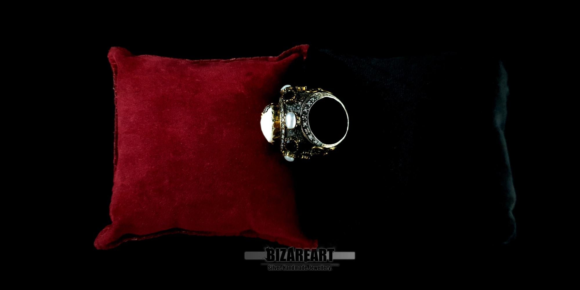 Side profile of a heavy 22g silver artisan ring showing intricate gold plating and floral details.