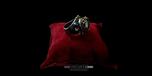 Three-quarter profile view of an artisanal oxidized silver statement ring with a large faceted purple amethyst gemstone.