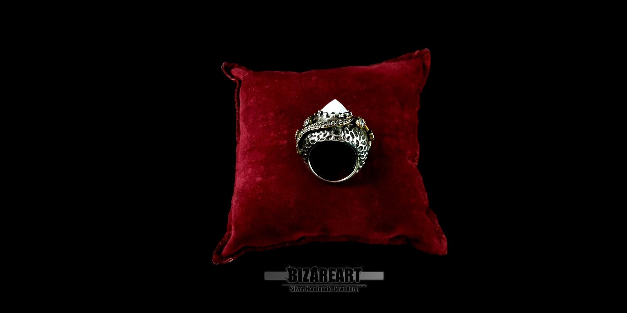 Back view of the detailed silver and gold statement ring showcasing the craftsmanship on a velvet pillow.