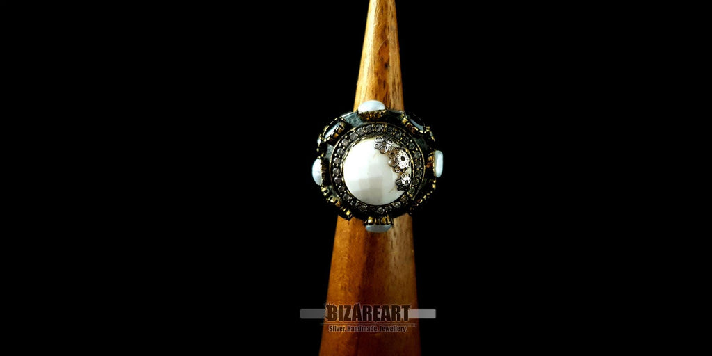 Front-facing view of the sterling silver gothic dome ring displayed on a wooden ring mandrel.