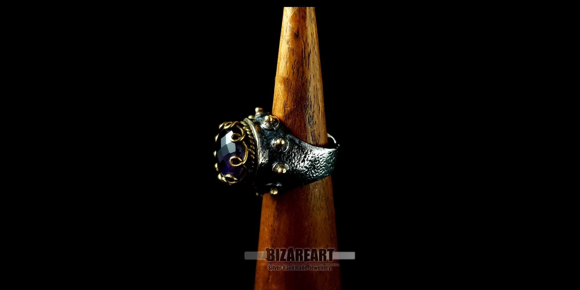 Side profile of a substantial 18g silver and gold-plated dome ring displayed on a wooden jewelry sizing cone.