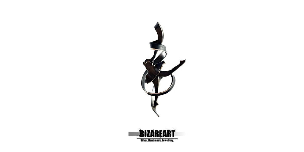 A high-contrast studio shot of the black oxidized silver pendant against a white background, emphasizing its silhouette and fluid lines.