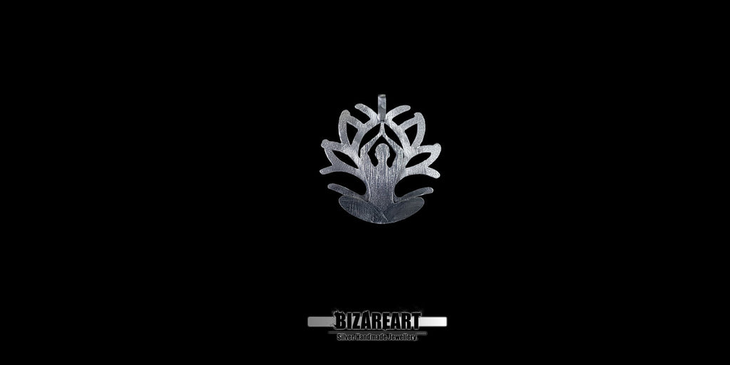 A front-facing studio shot of the Silver Yoga Pendant hanging from a steel ball chain against a deep black background. The lighting highlights the intricate hand-carved textures and the "BizarEart" brand logo below.