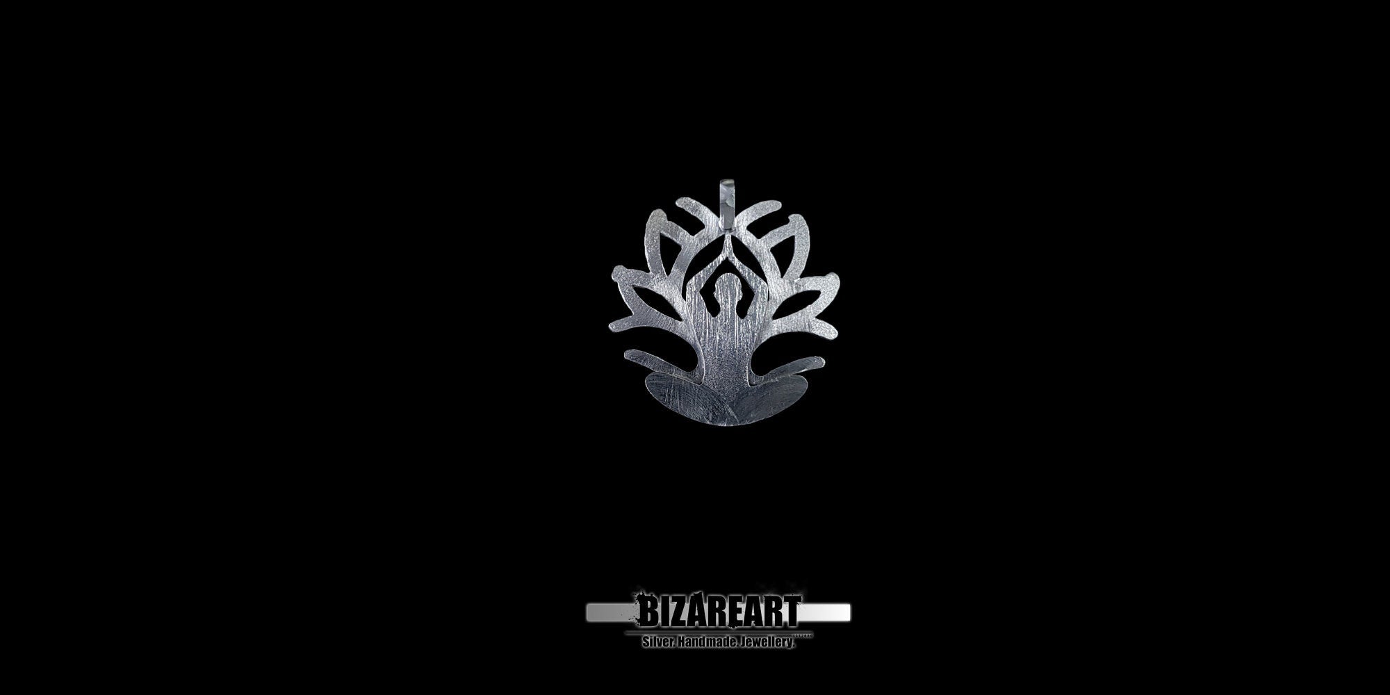 A front-facing studio shot of the Silver Yoga Pendant hanging from a steel ball chain against a deep black background. The lighting highlights the intricate hand-carved textures and the "BizarEart" brand logo below.