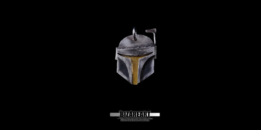 A close-up shot of a hand holding the 925 sterling silver Boba Fett pendant to show its actual size and scale.