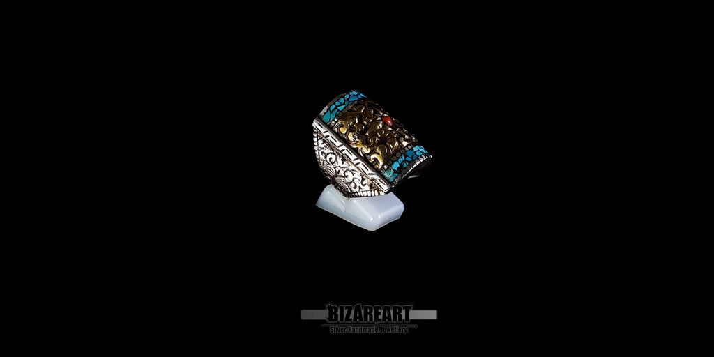 Detailed side view of a vintage Himalayan artisan ring, showcasing the intricate hand-engraving on the flat-edged silver band.