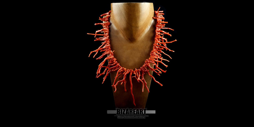 Luxury Mediterranean red coral branch necklace styled on a gold mannequin neck to show fit, length, and scale.