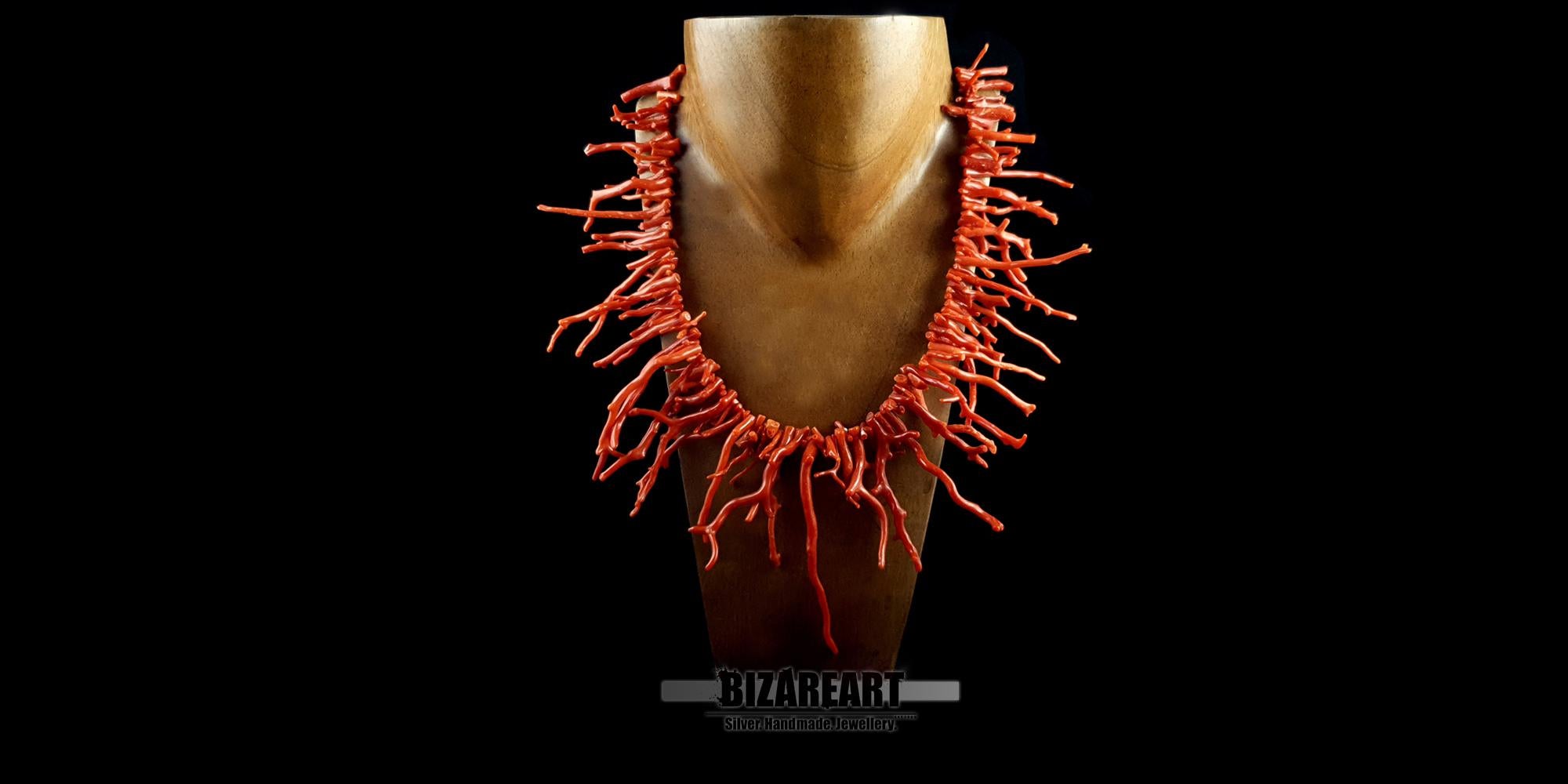 Luxury Mediterranean red coral branch necklace styled on a gold mannequin neck to show fit, length, and scale.