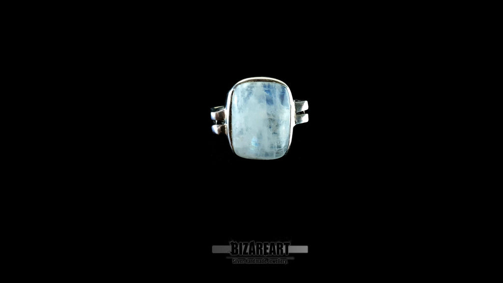 Macro shot of the moonstone surface highlighting the natural milky textures and pale blue light flashes.