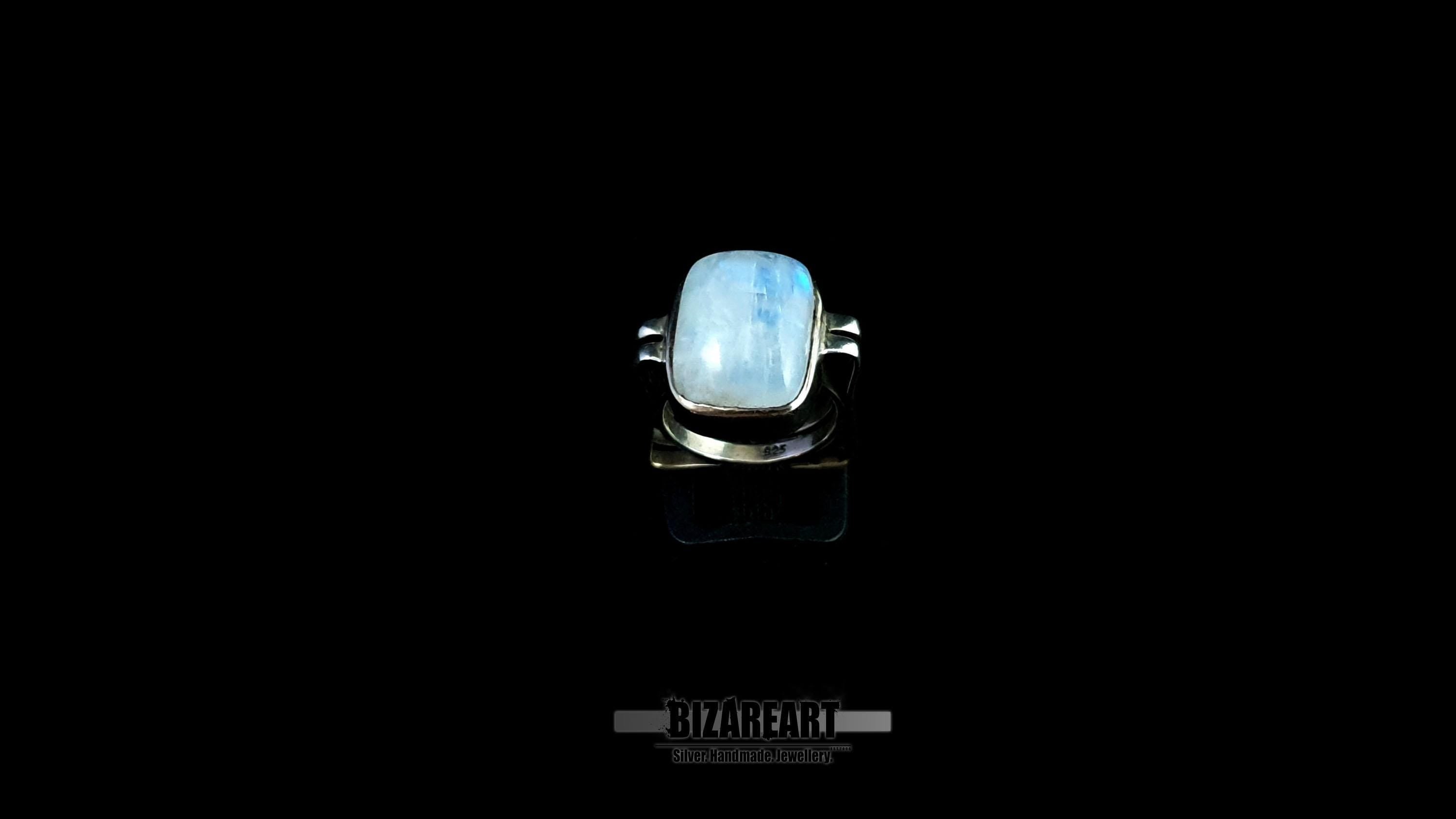 Front-facing view showing the elevation of the moonstone within its open-frame silver setting.