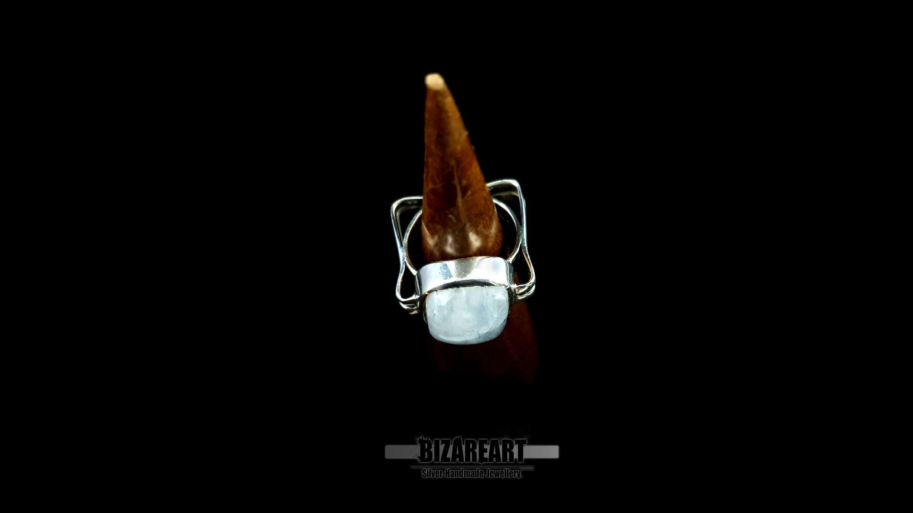 A vertical view of the ring on a display cone, highlighting the bold face dimensions of the gemstone.