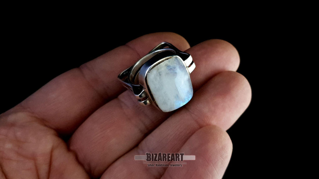 A hand-held shot showing the ring tilted toward the light to reveal the depth and character of the natural stone.